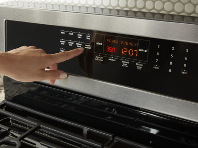 Person selecting a bake setting on a Maytag® range