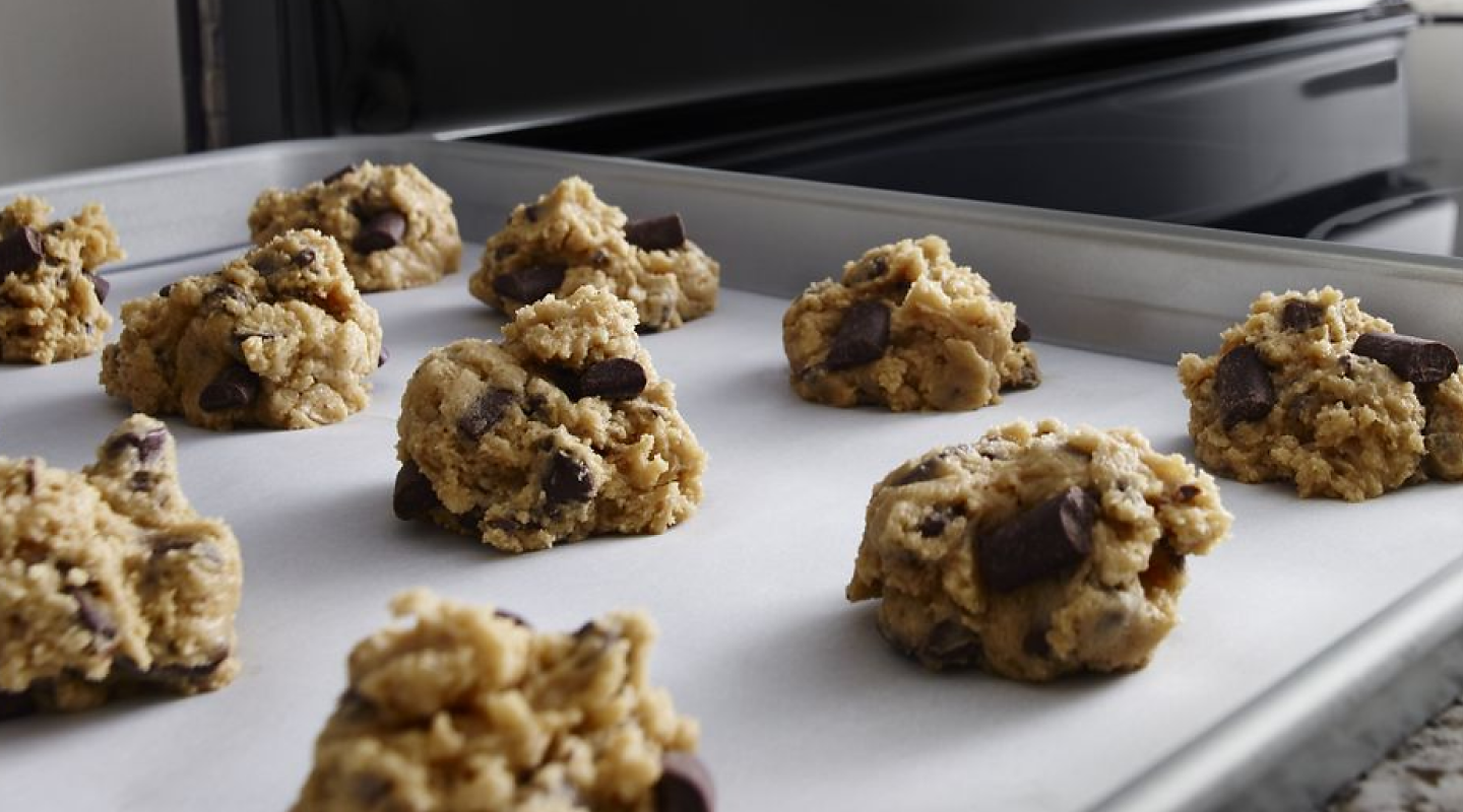 Cookie dough clusters on a baking sheet.