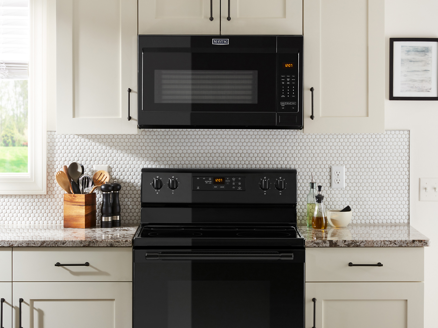 Steam escaping a pot on a gas range under a Maytag® over-the-range microwave