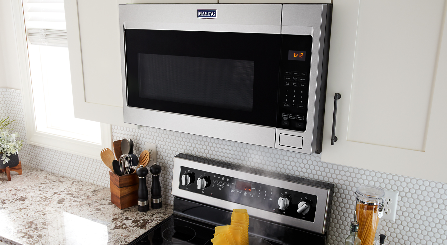 A Maytag® stainless steel over-the-range microwave in a modern kitchen