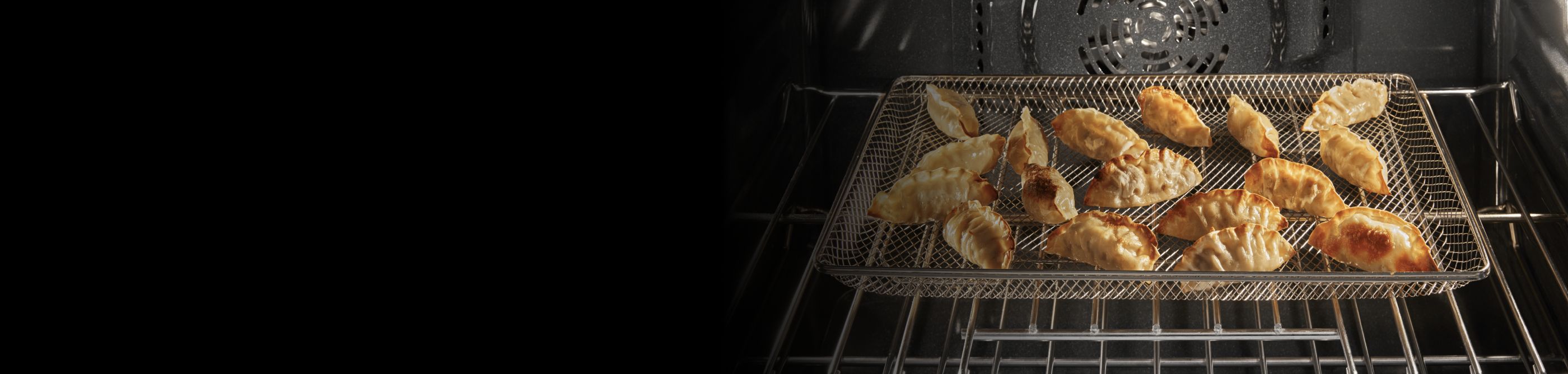 Several potstickers in a basket inside an oven