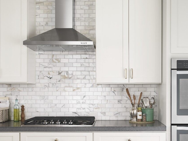 Stainless steel Maytag® range hood in a bright kitchen Stainless steel Maytag® range hood in a bright kitchen