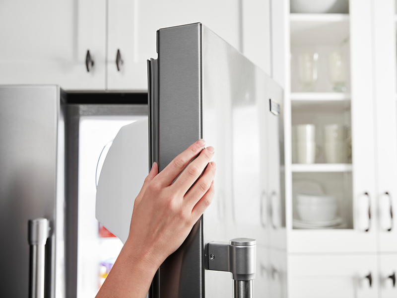 Person opening refrigerator door