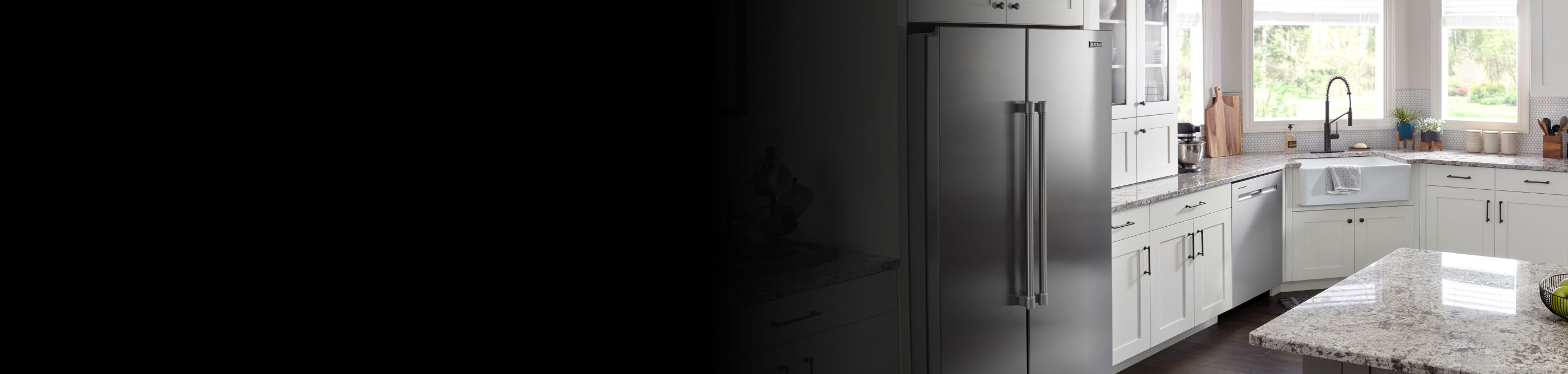 Stainless steel side-by-side refrigerator in white cabinetry 