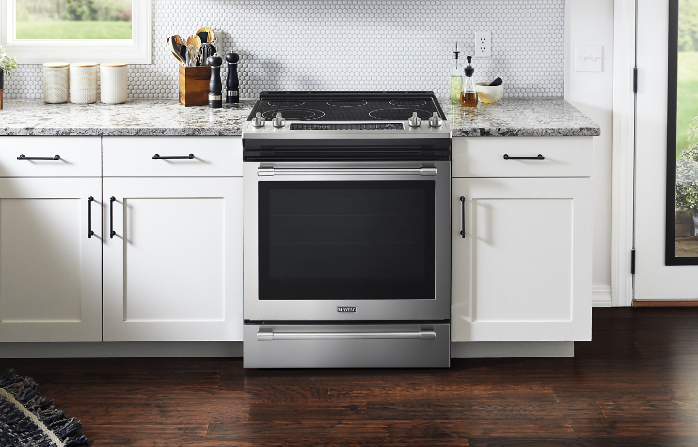 A convection range centered in a kitchen space.