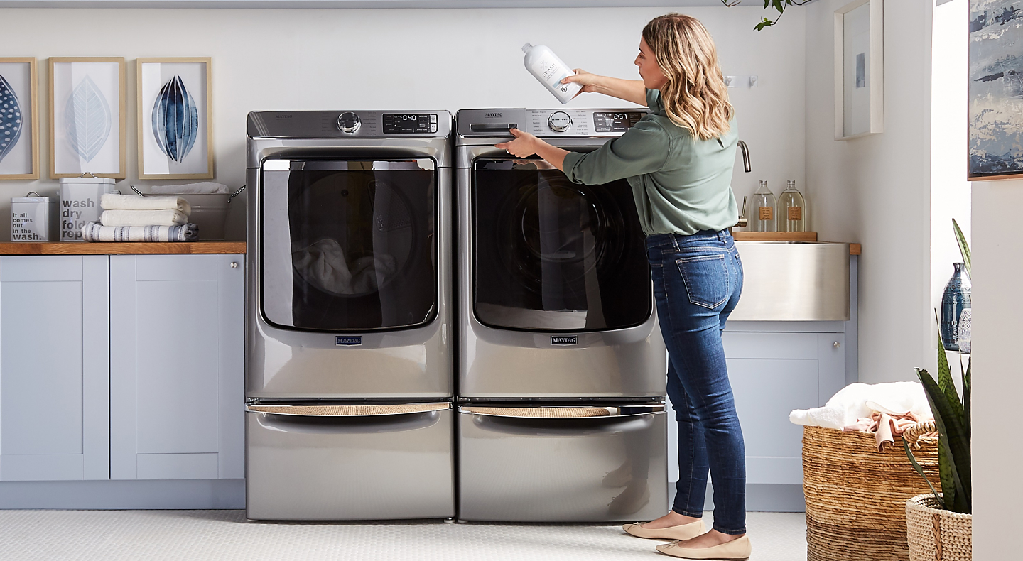 Person adding detergent to a washing machine