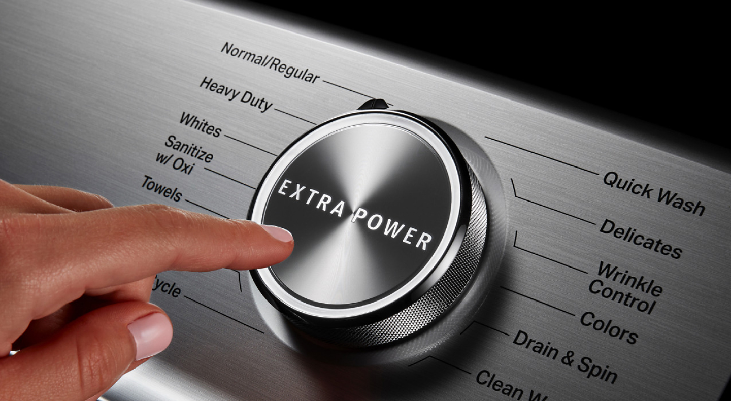 Finger pressing extra power button on washing cycle control panel