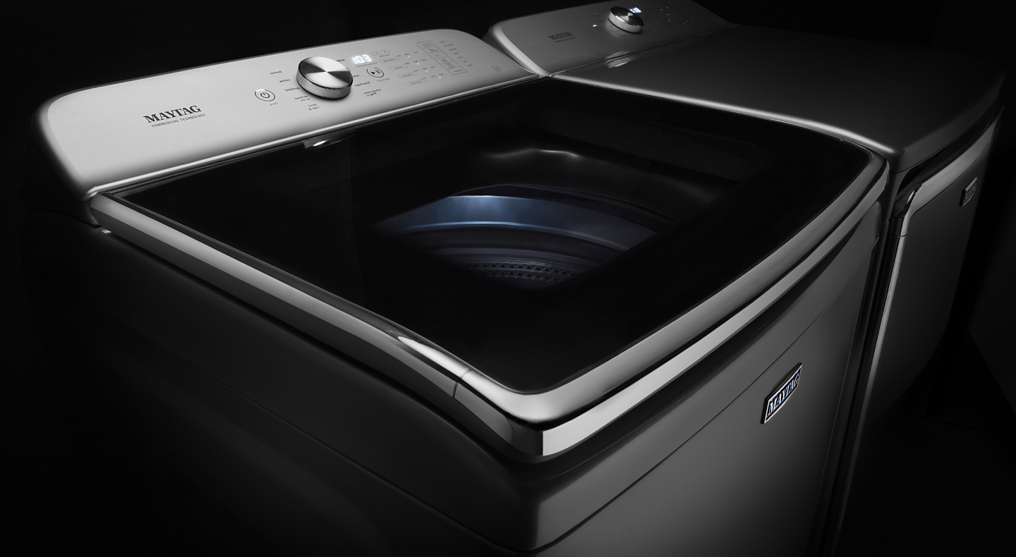 Maytag® stainless steel top load washing machine against black background Maytag® stainless steel top load washing machine against black background