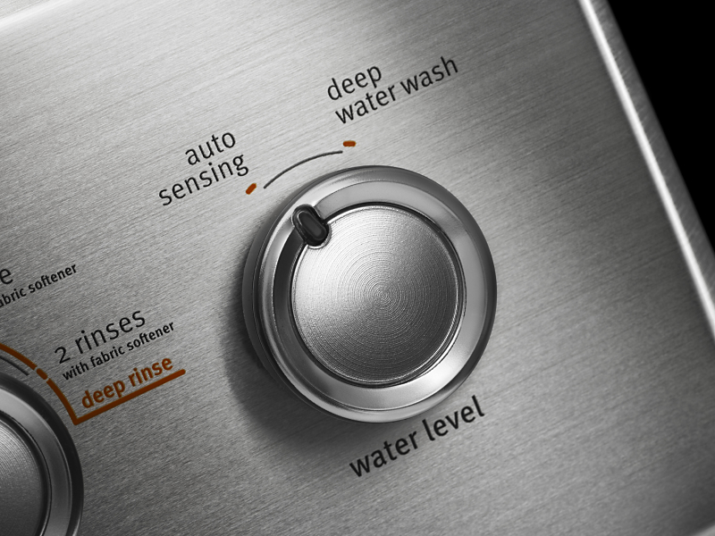 Close up of knob turned to “auto sensing” on control panel of washing cycles Close up of knob turned to “auto sensing” on control panel of washing cycles