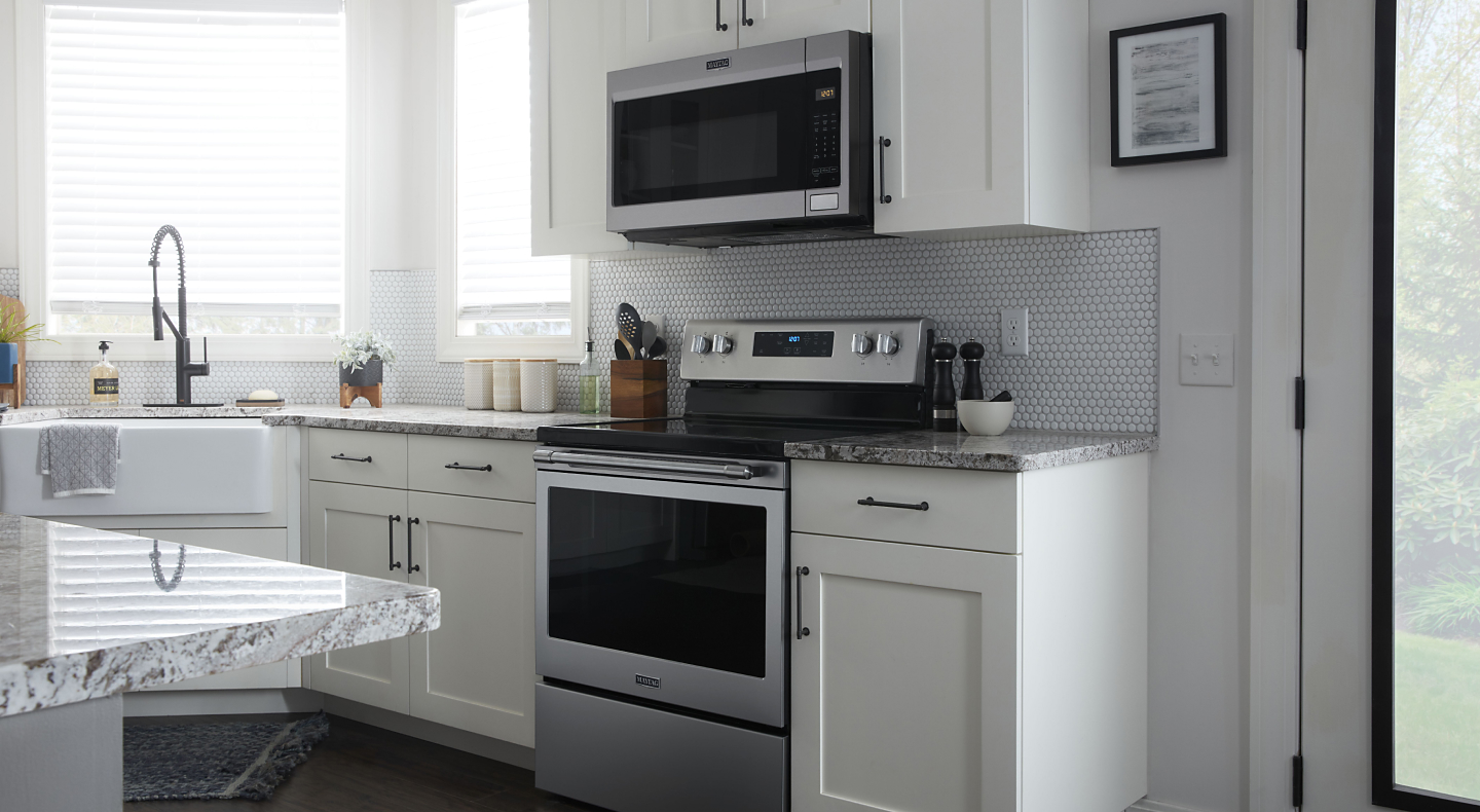 A Maytag® oven and over-the-range microwave in a modern kitchen.