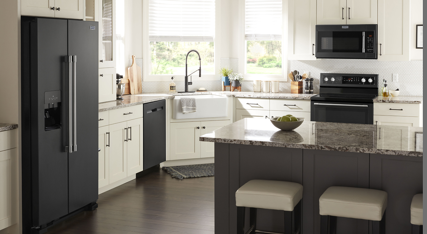 A Maytag® oven, over-the-range microwave, dishwasher and refrigerator in a modern kitchen.