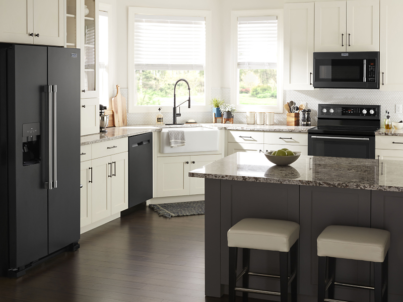 A Maytag® oven, over-the-range microwave, dishwasher and refrigerator in a modern kitchen.