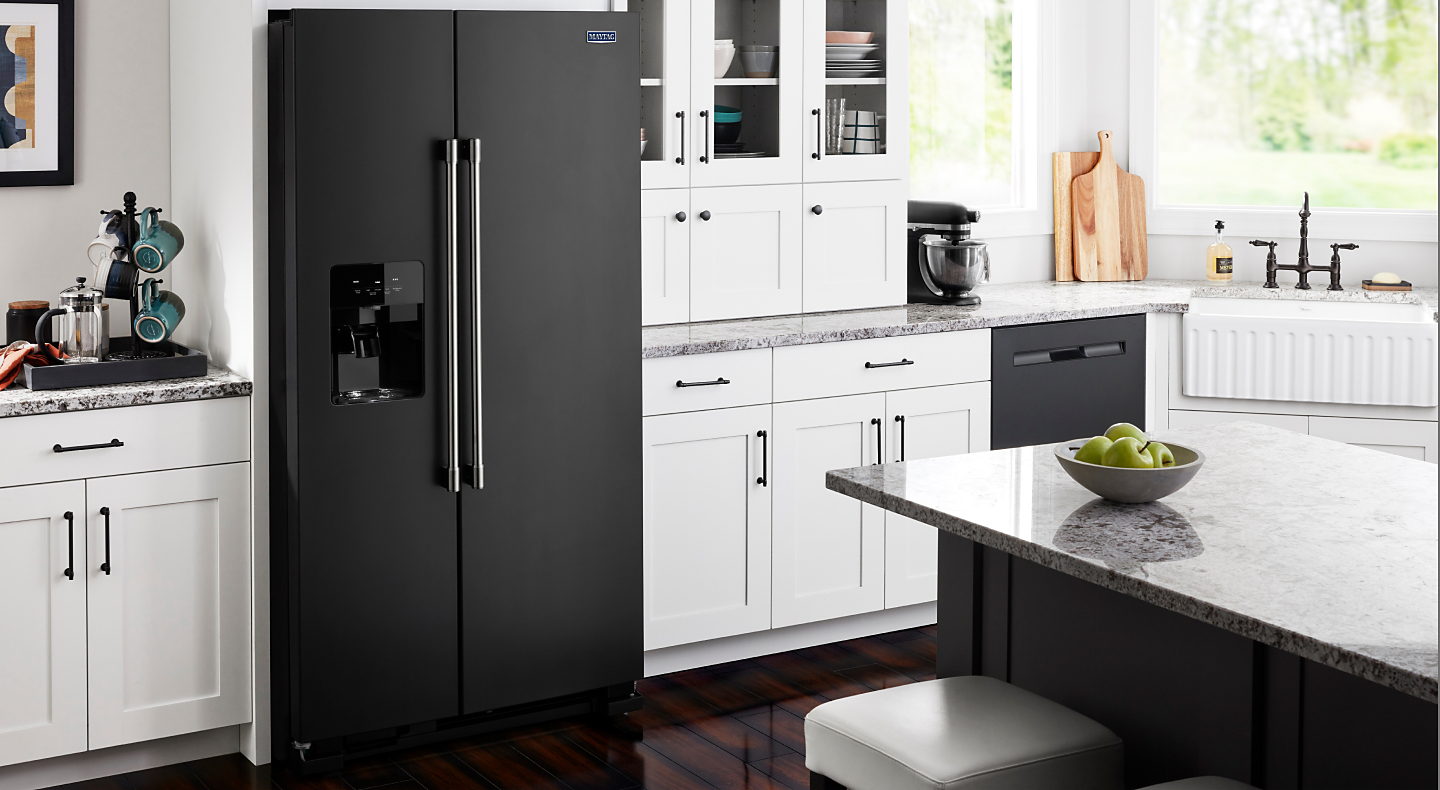 Matt black Maytag® side-by-side refrigerator built into white cabinets