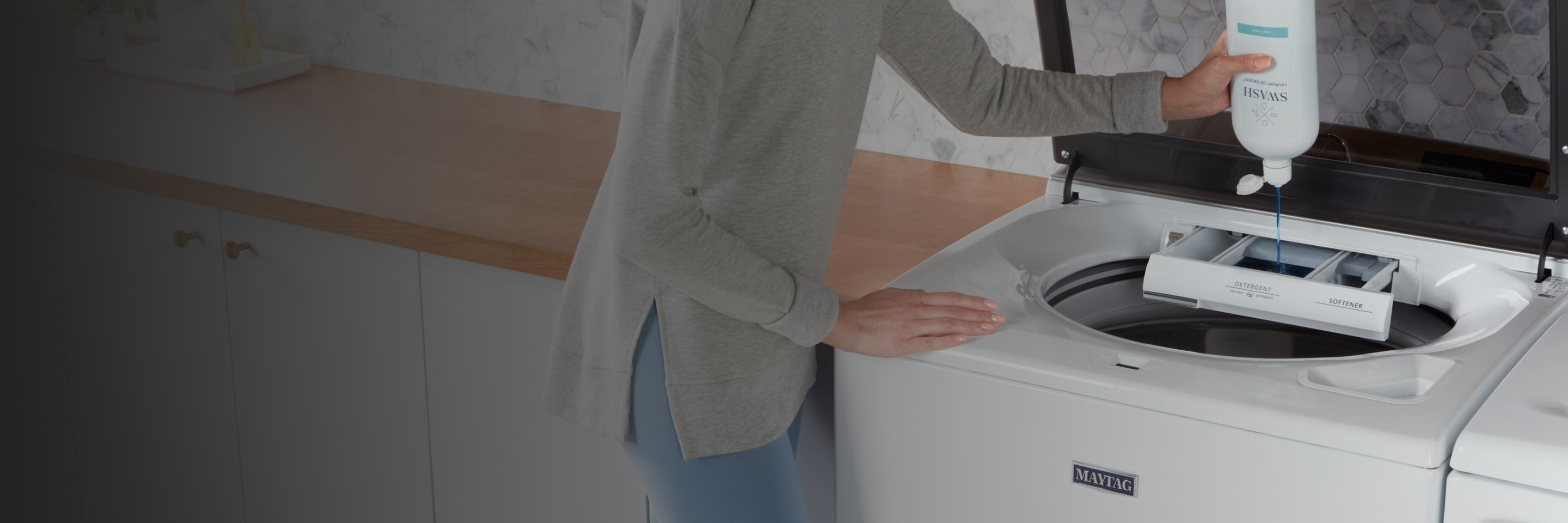 Filling a top-load washer with Swash® Laundry Detergent.