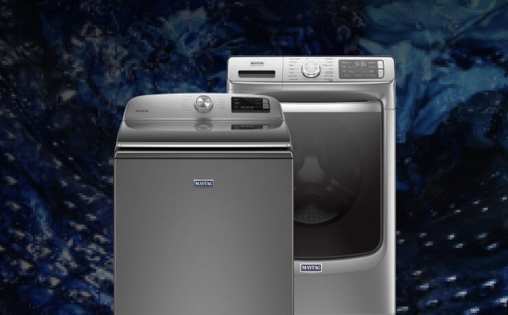 Interior view of a Maytag® washing machine cleaning blue clothes.
