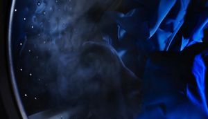 Clothes tumbling in washer at night.