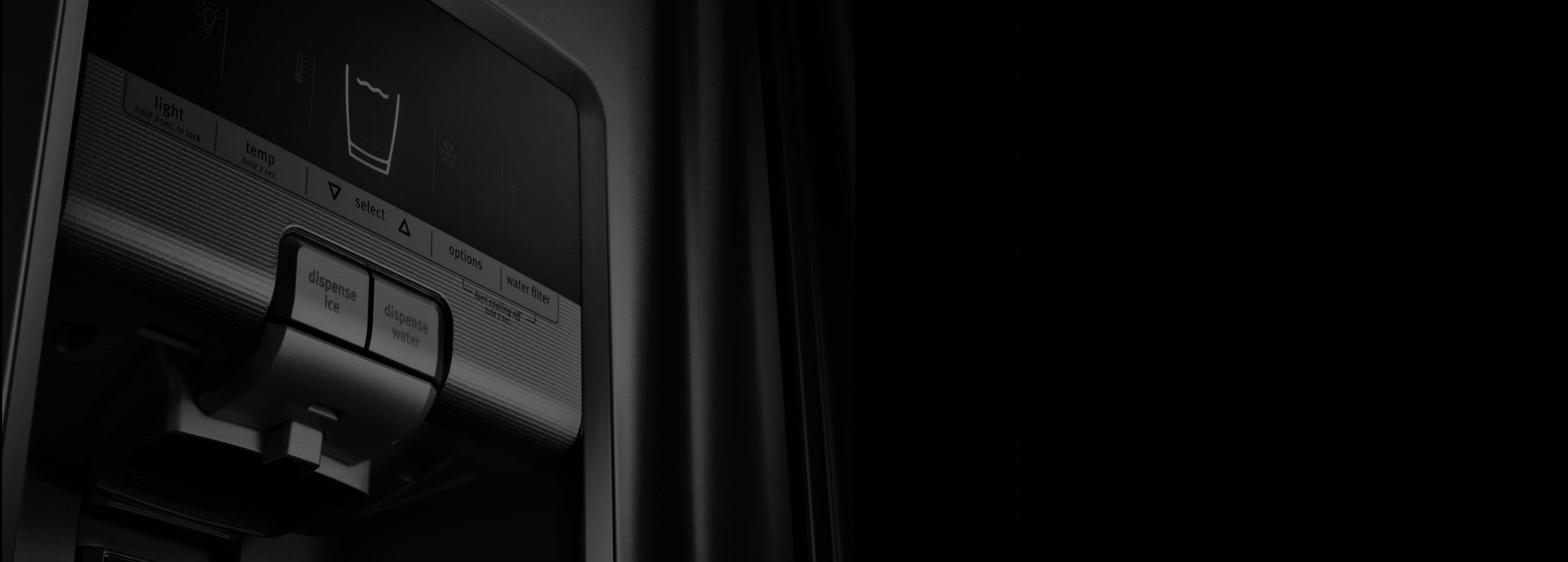 Dramatic, close-up shot of a black Maytag refrigerator ice and water dispenser.