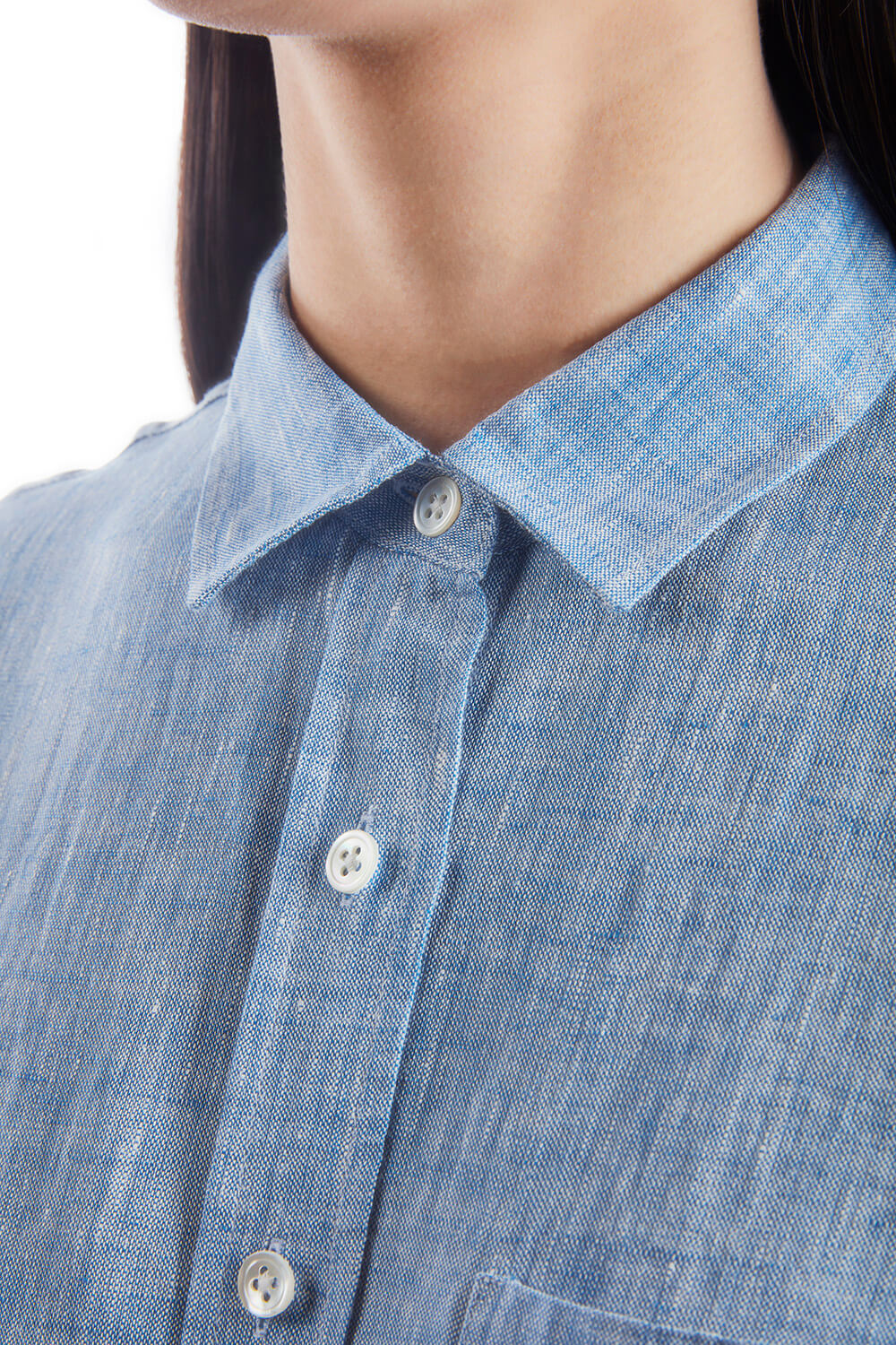 A woman wearing a chambray button down shirt