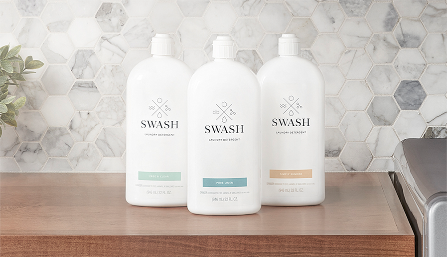 Three different bottles of Swash arranged on a counter.
