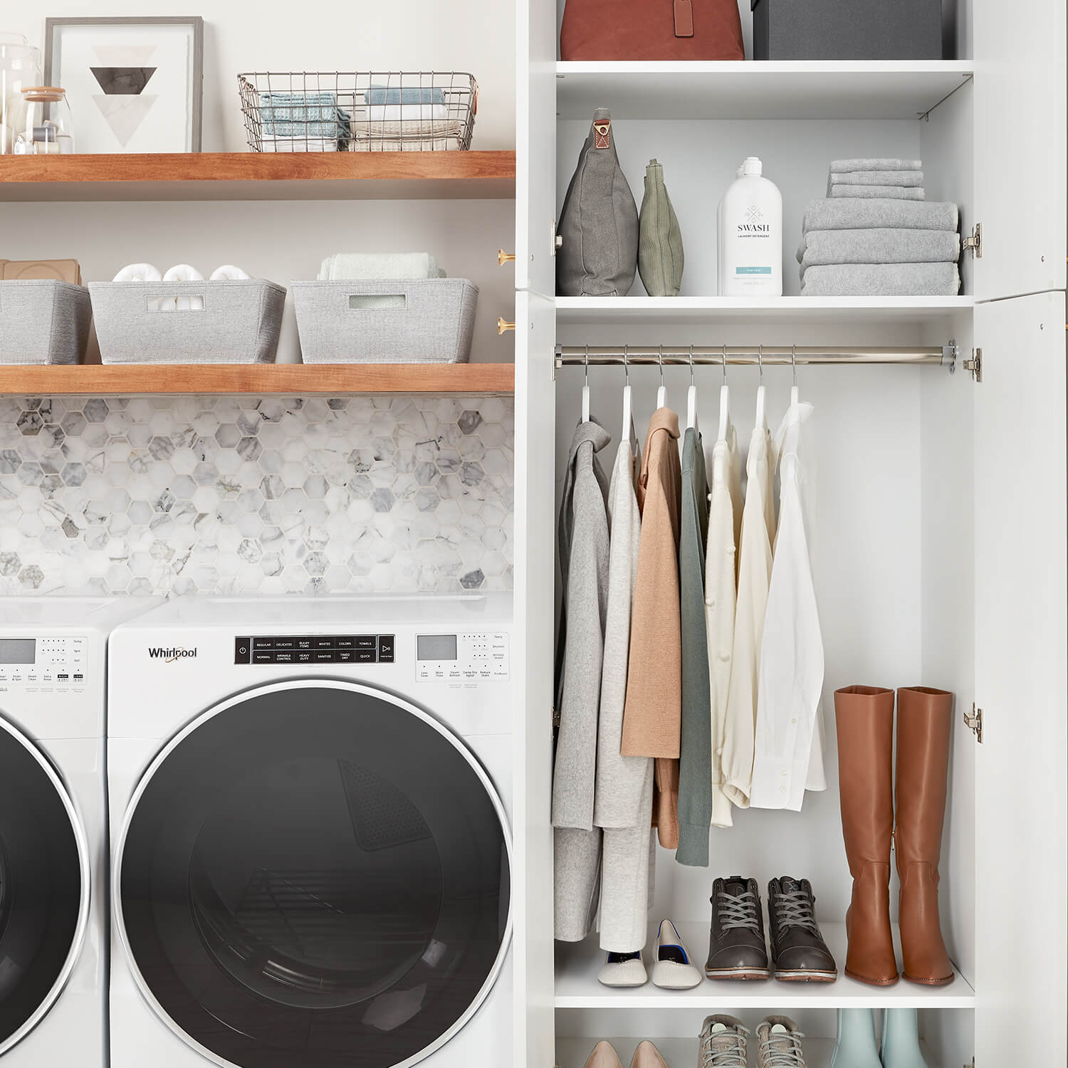 A look at inside of a cabinet in a laundry room with hanging space that is neatly organized next to a white Whirlpool washer and dryer