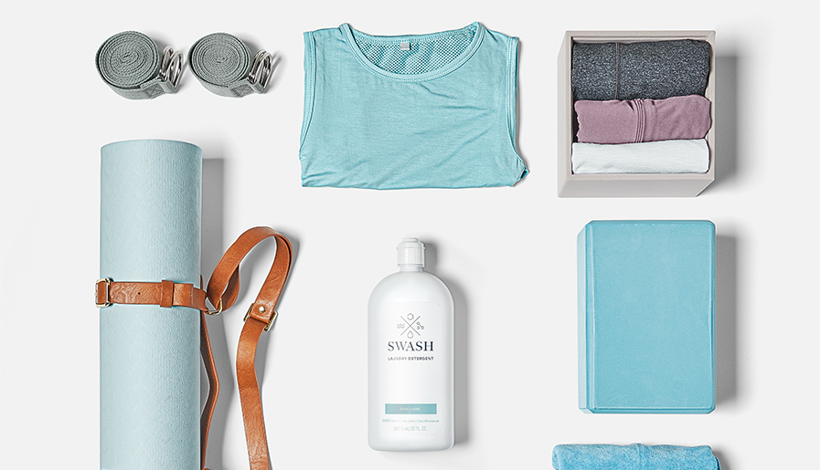 Swash Pure Linen Laundry Detergent next to towels and other workout supplies