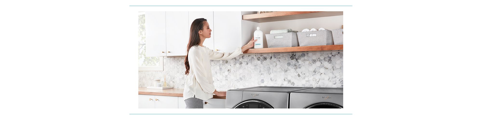 A woman puts a bottle of Swash laundry detergent on a shelf in a laundry room.