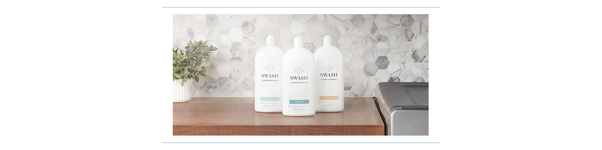 Three bottles of Swash lined up on a counter.