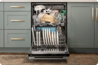 An opened Whirlpool Dishwasher with each rack full. The lower rack is pulled out. On the racks are plates, tupperware, bowls, baking trays and more