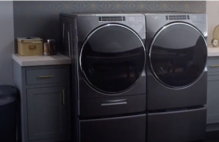 Whirlpool® Top Load Washer and Dryer in a laundry room