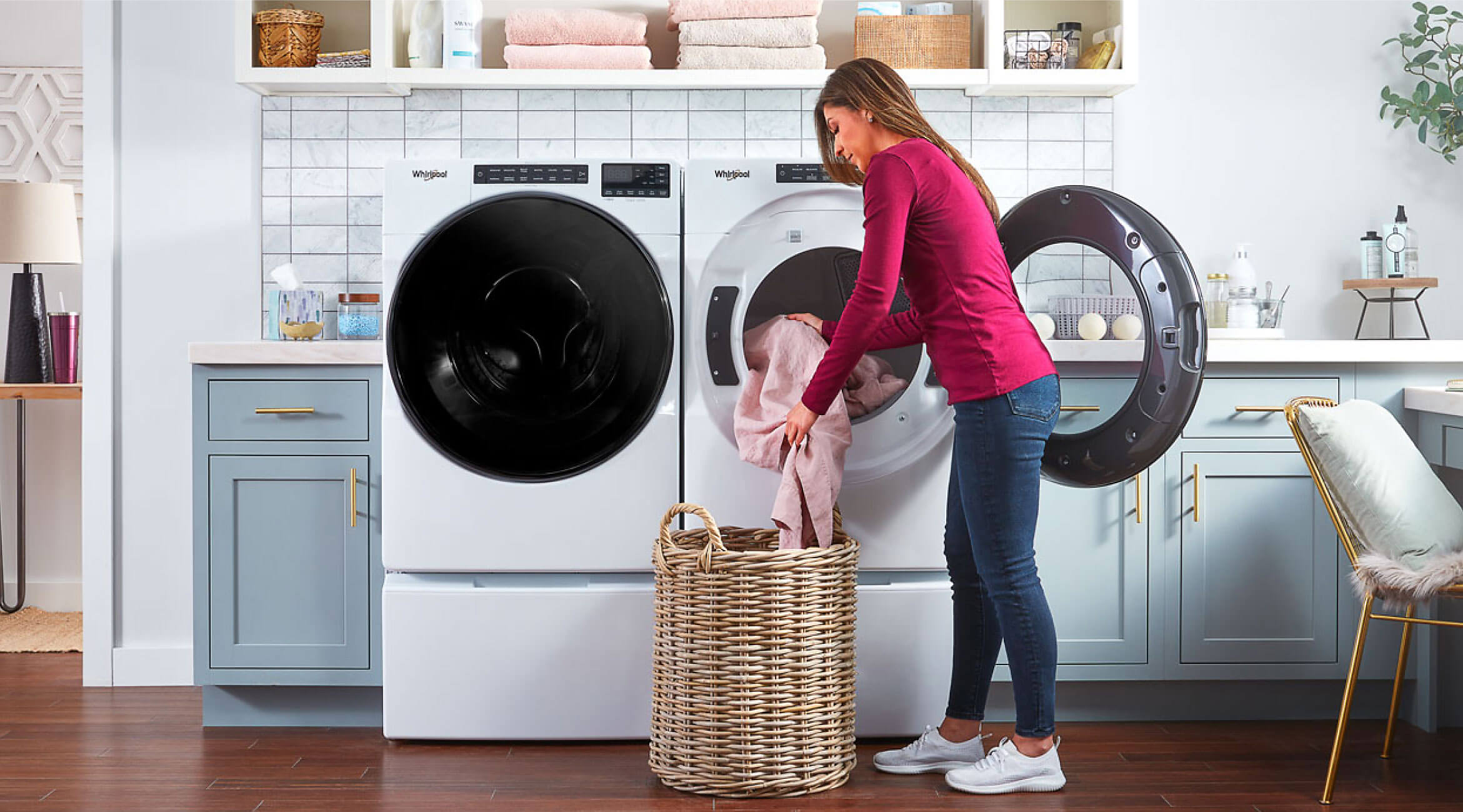 Person loading clothes into a Whirlpool® Front Load Dryer