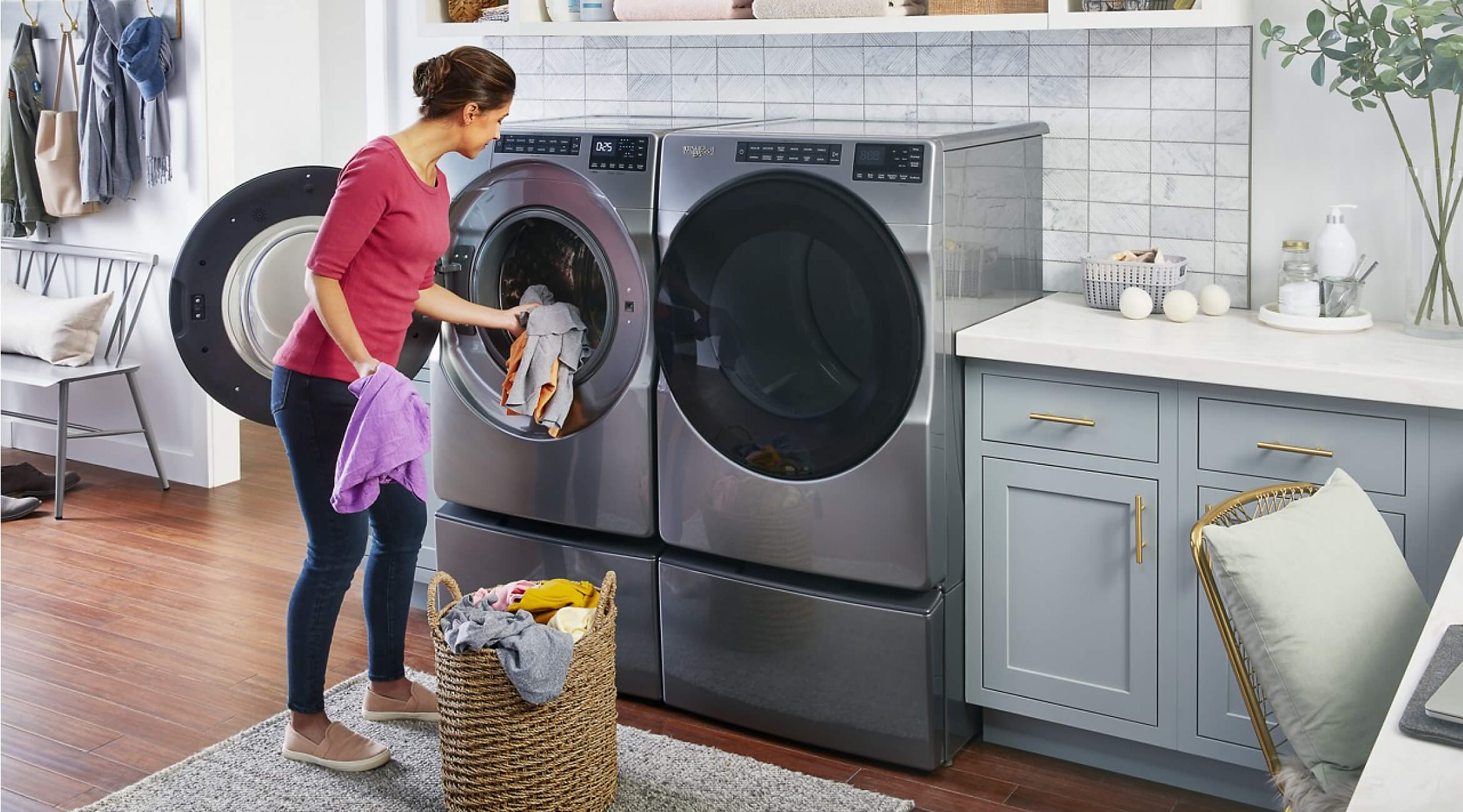 Woman loading clothes into a Whirlpool® Front Load Washer