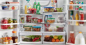 A Whirlpool® refrigerator loaded with a variety of foods