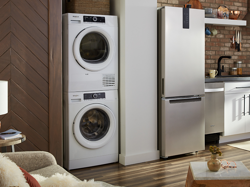 A Whirlpool® stacked washer and dryer in a modern kitchen
