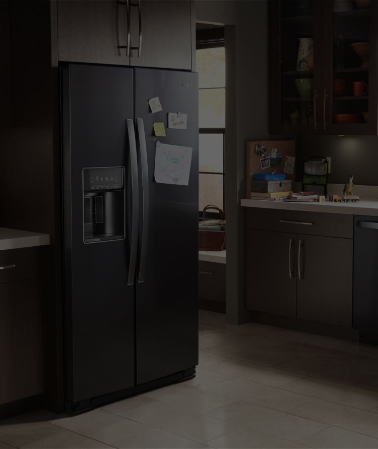 A Whirlpool® kitchen appliance suite featuring the low-profile microwave hood combination.