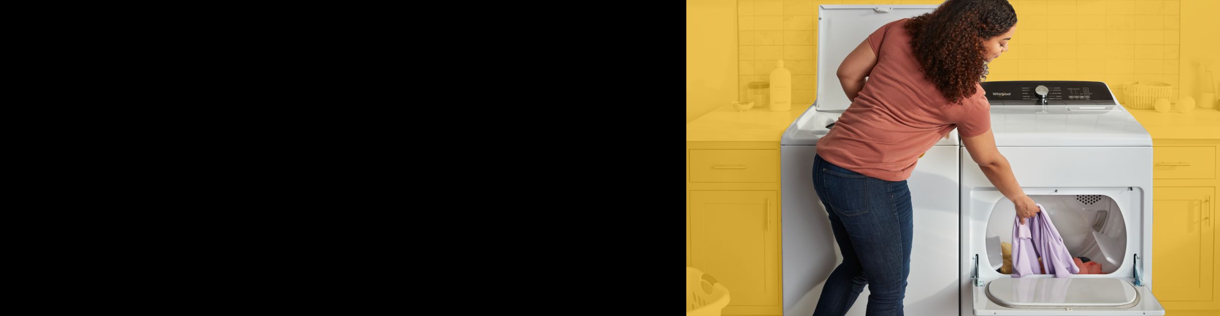 Person putting clothing into a Whirlpool® dryer.