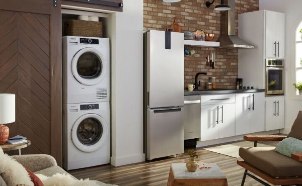 Small kitchen with compact appliances, including a washer and dryer