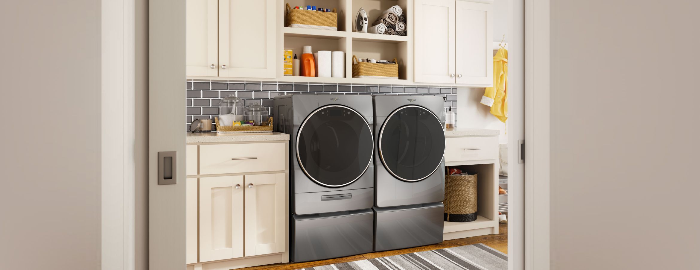 A Whirlpool washer and dryer in a modern laundry room.