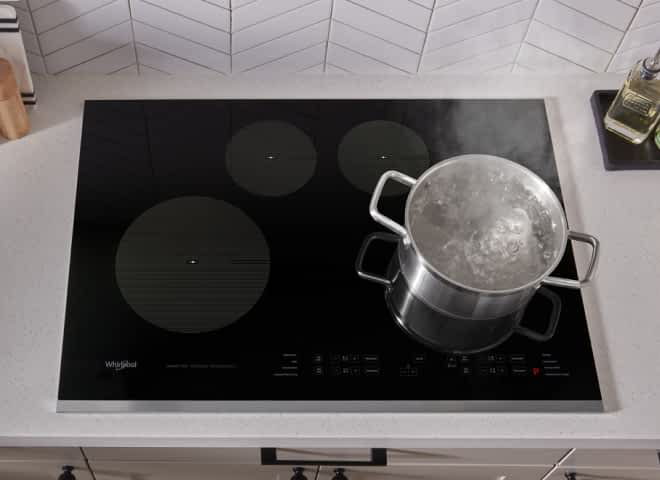 Water boiling in a large pot on Whirlpool® Electric Cooktop