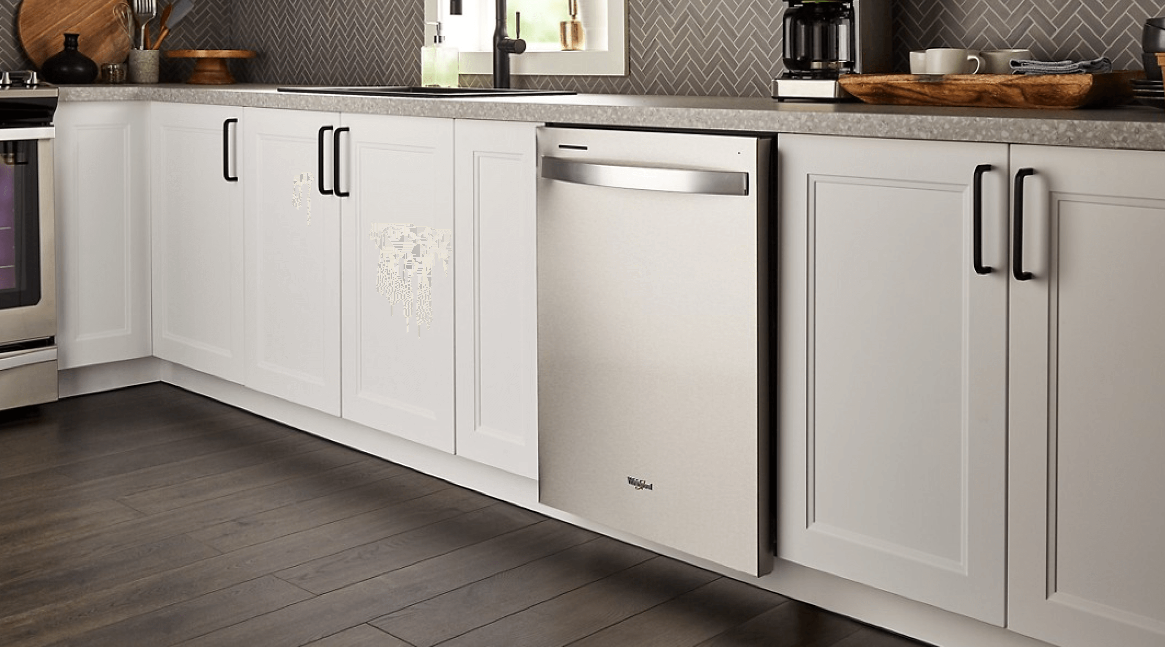 A Whirlpool® Standard Dishwasher in a kitchen with white cabinets