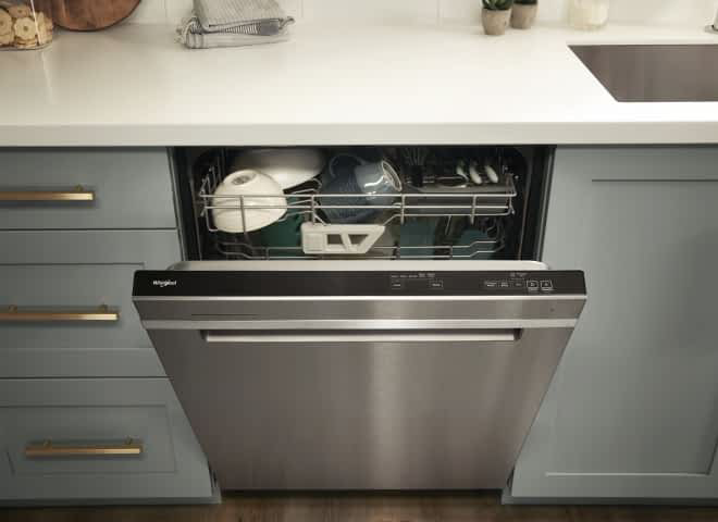A Whirlpool® Dishwasher with the door slightly open, showing the 3rd Rack
