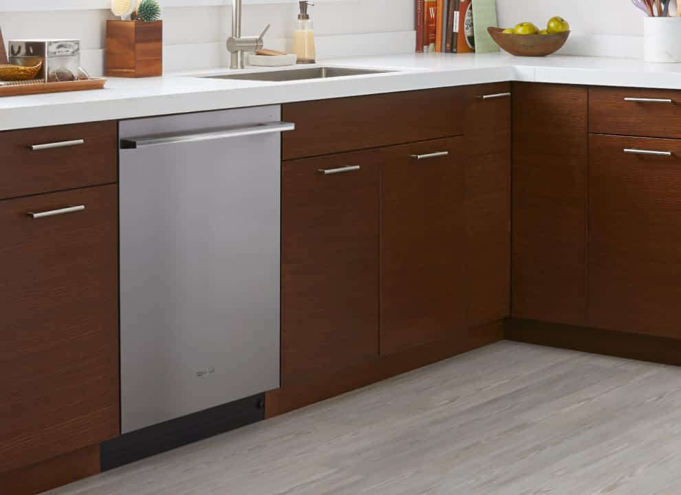 A Whirlpool® Dishwasher in a kitchen with brown cabinets