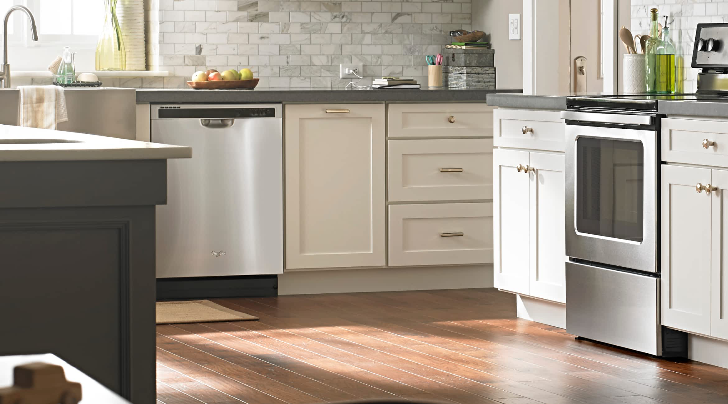 A Whirlpool® Starter Dishwasher in a kitchen with white cabinets