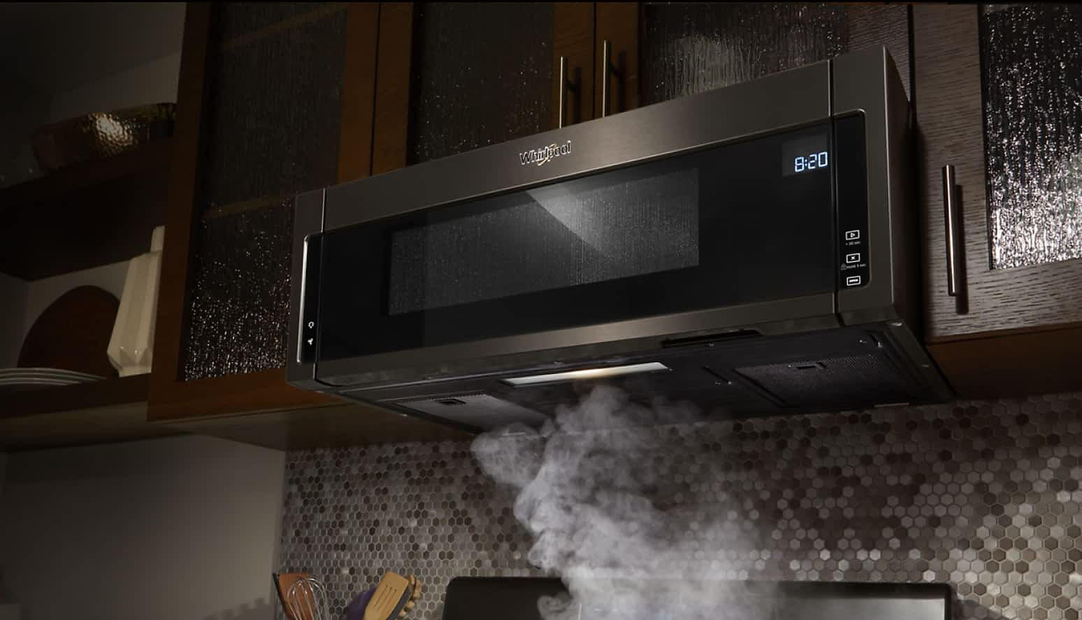 A Whirlpool® Low Profile Over-The-Range Microwave removes steam from the cooktop