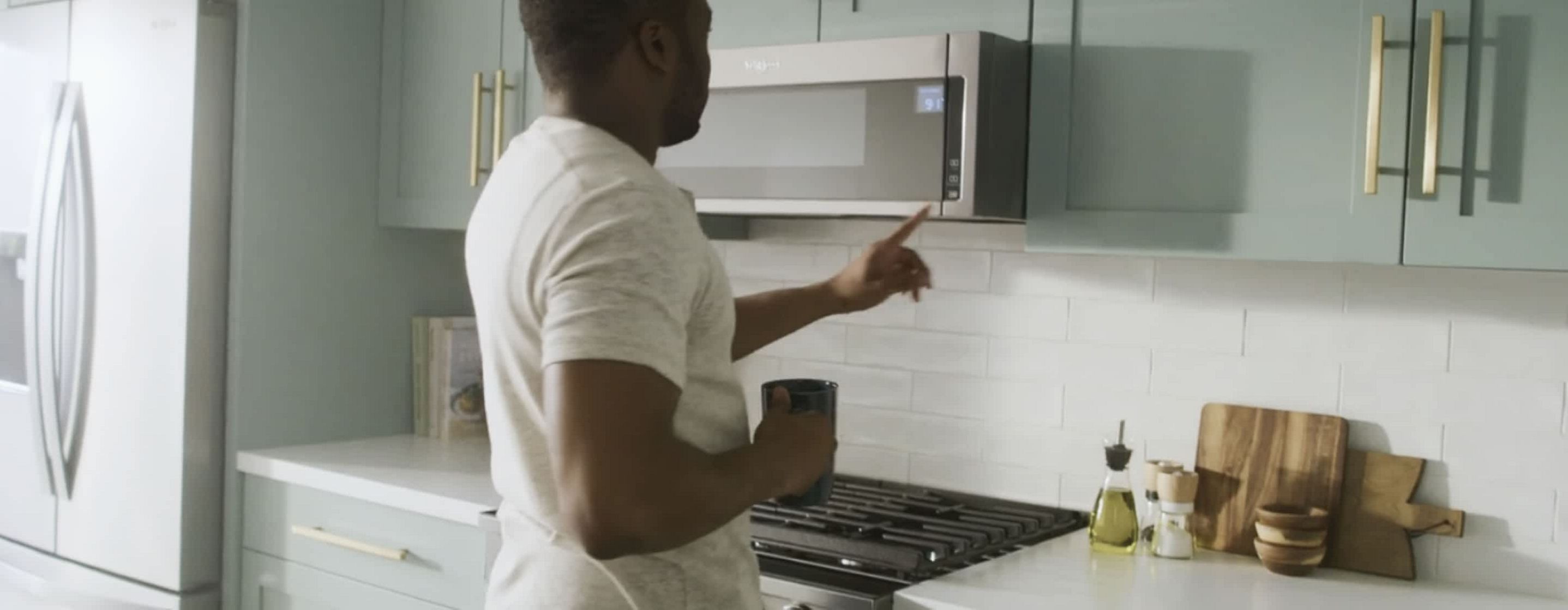 A man sets the time on his microwave