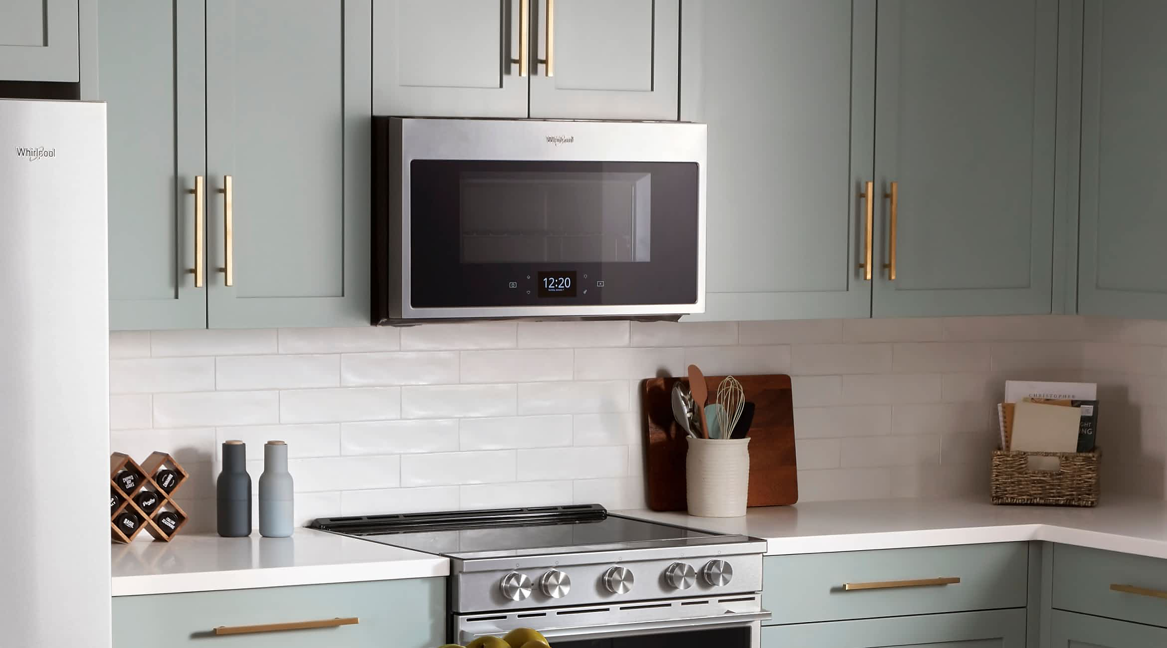A modern kitchen with a Whirlpool® Over-The-Range Microwave