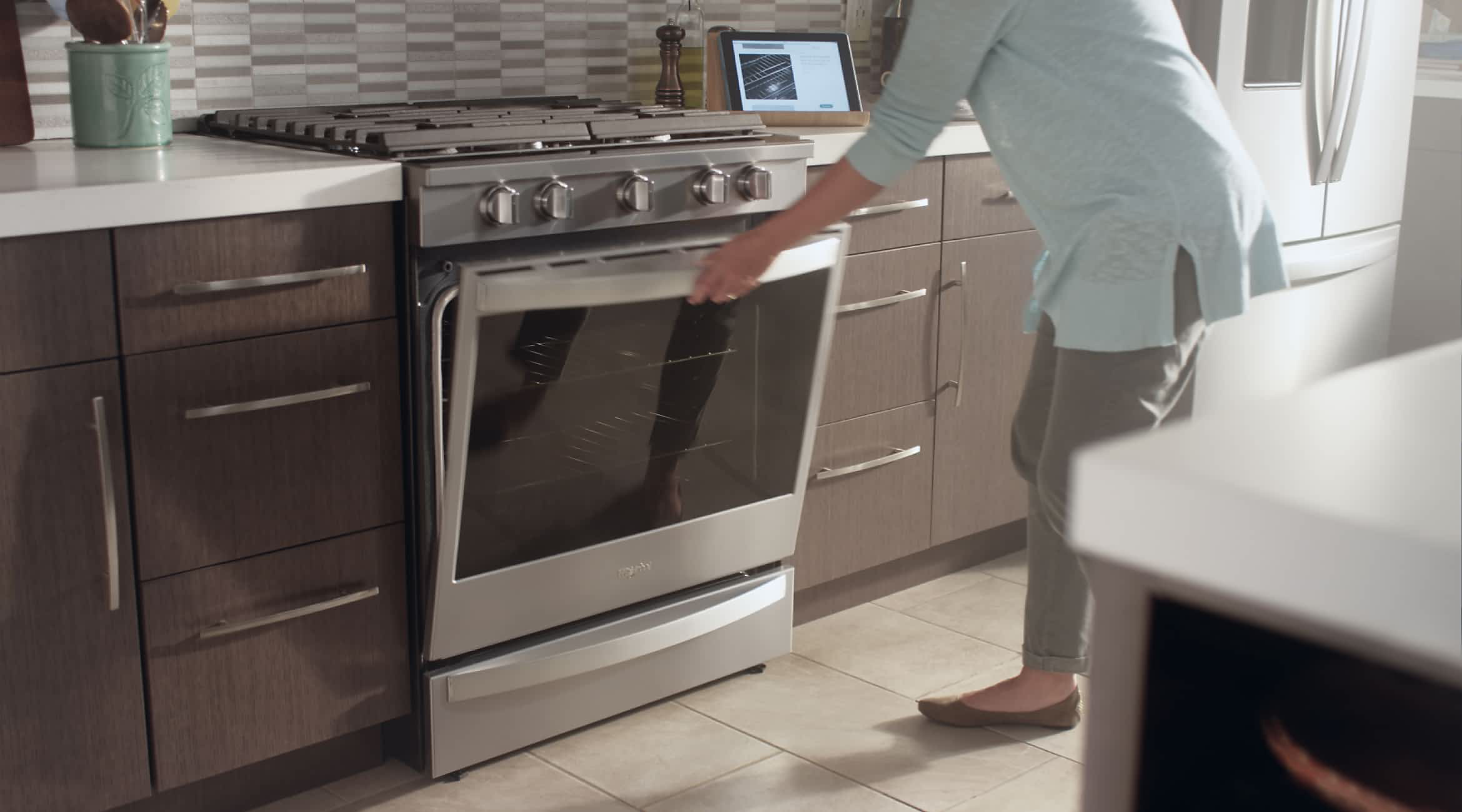 A woman opening a Whirlpool® Premium Oven