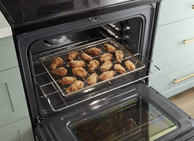 Chicken wings cooking in a Whirlpool® Range with Air Fry Mode