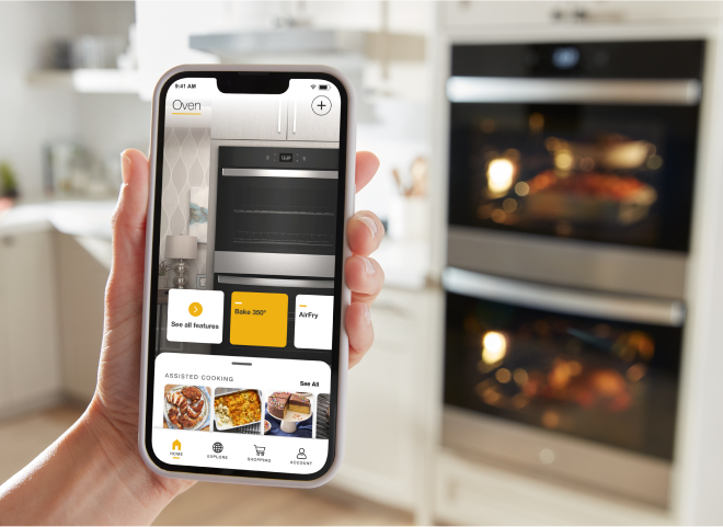A person using their smartphone to control their Whirlpool® Wall Oven