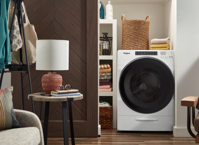 White Whirlpool® All-In-One Washer & Dryer inside of a closet with a sliding barn door