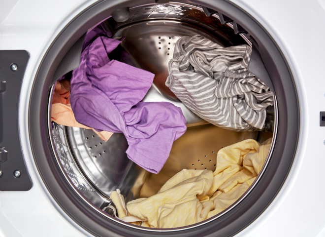 Full load of colorful clothes in a Whirlpool® All-In-One Washer & Dryer